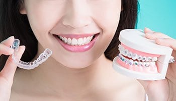 Woman comparing Invisalign and regular braces