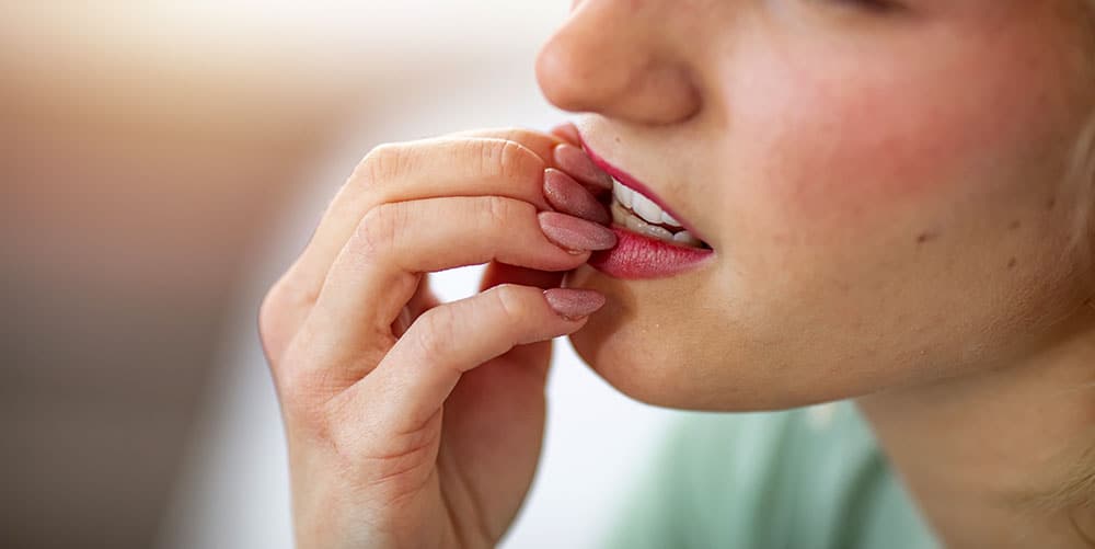 Woman biting nails