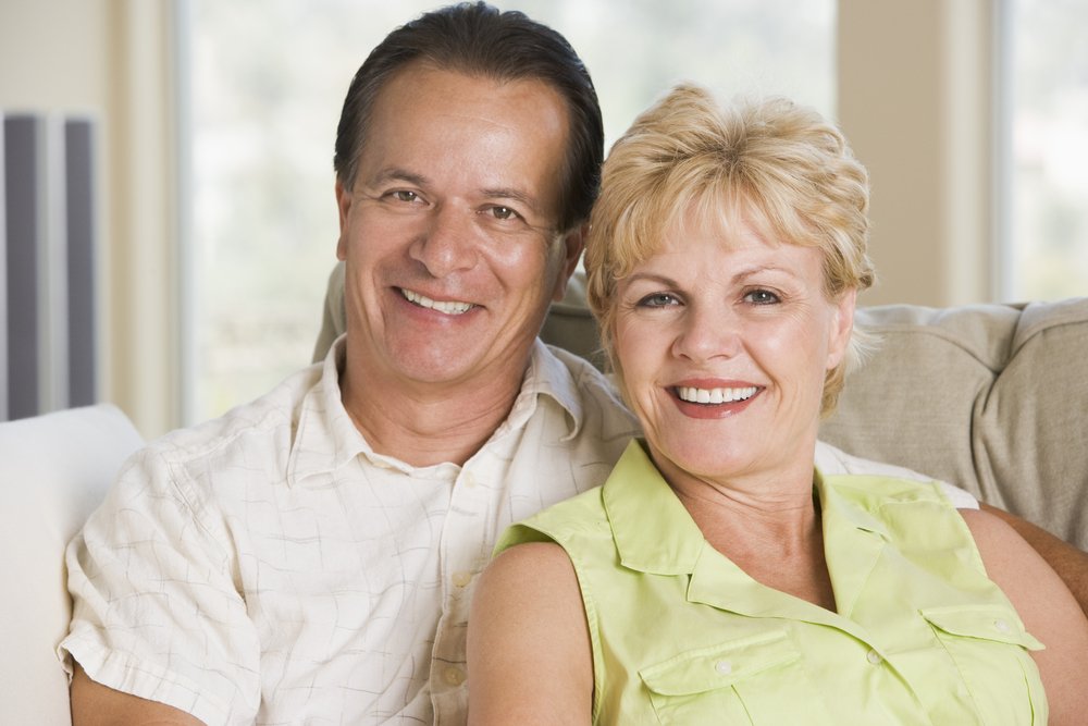 Smiling couple with natural looking ceramic dental implants in Beverly Hills